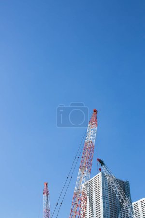 Photo for Daytime view of cranes at construction side in Japanese city - Royalty Free Image