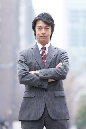 Photo for Portrait of adult japanese businessman on city street - Royalty Free Image