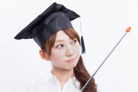 Photo for Woman wearing a graduation hat with pointer - Royalty Free Image