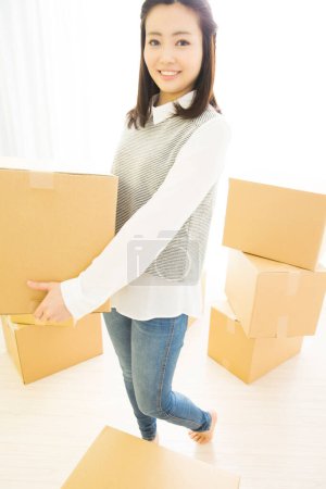 Photo for Young asian  woman holding box - Royalty Free Image