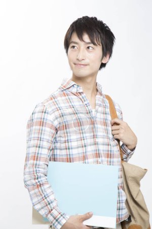 Photo for Portrait of a young student holding a folder - Royalty Free Image