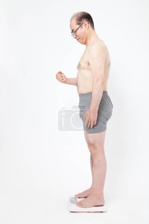 Téléchargez les photos : Japonais gros homme en sous-vêtements avec des balances de poids. Concept de perte de poids - en image libre de droit