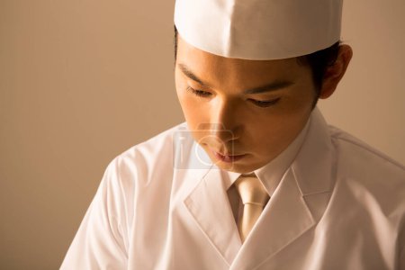 Photo for Young asian chef, studio shot - Royalty Free Image