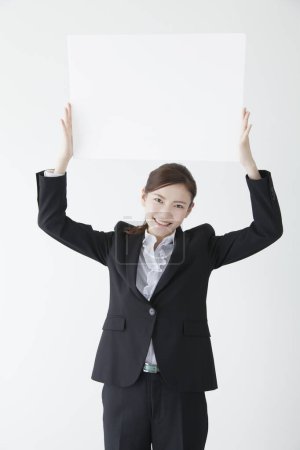 Photo for Businesswoman holding white blank board. - Royalty Free Image