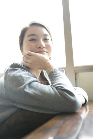 Foto de Hermosa joven japonesa mujer sentado en la cafetería - Imagen libre de derechos