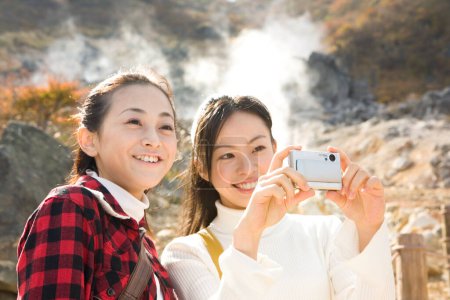 Photo for Asian girls with camera taking photo - Royalty Free Image