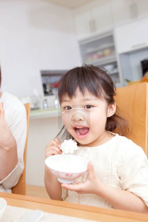 Photo for Asian mother and daughter eating breakfast - Royalty Free Image