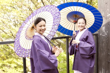 two young women with japanese traditional kimonos with umbrellas