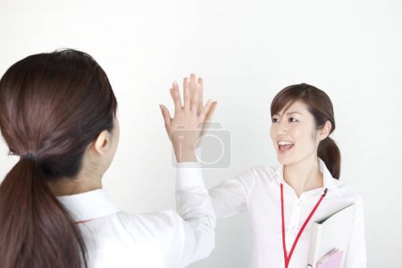 Photo for Young woman giving high five to friend - Royalty Free Image