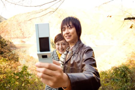Photo for Young woman and her husband taking selfie  outdoors - Royalty Free Image
