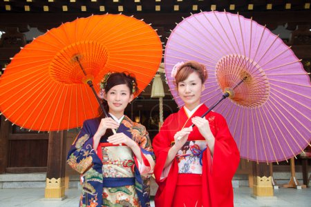Photo for Beautiful japanese girls wearing kimono with umbrellas - Royalty Free Image