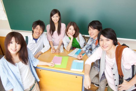 Photo for Young asian groupmates posing in classroom - Royalty Free Image