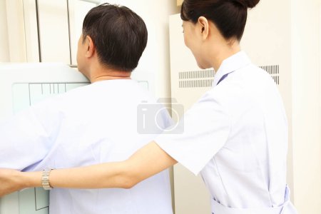 Photo for Young man getting medical exam from doctor - Royalty Free Image