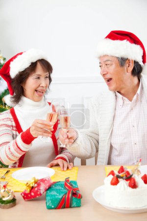 Photo for Asian senior  couple  drinking champagne  Christmas at home - Royalty Free Image