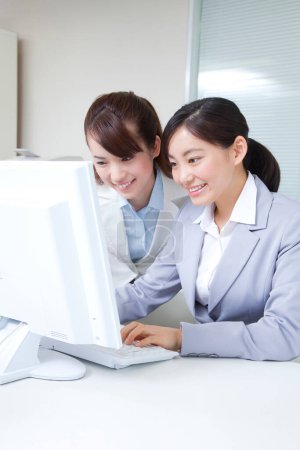 Photo for Portrait of beautiful Japanese businesswomen working with computer in office - Royalty Free Image