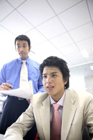 Photo for Young asian business people at work - Royalty Free Image
