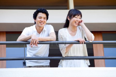 Photo for Portrait of happy asian young couple smiling on terrace - Royalty Free Image