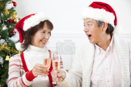 Photo for Asian senior  couple   drinking champagne  Christmas at home - Royalty Free Image