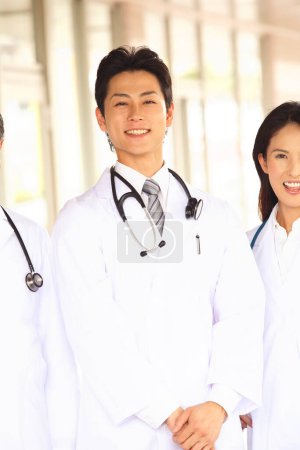 Photo for Japanese medical staff standing near hospital - Royalty Free Image