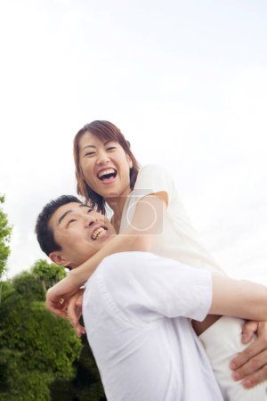 Téléchargez les photos : Heureux jeune asiatique couple avoir amusant dans été parc - en image libre de droit