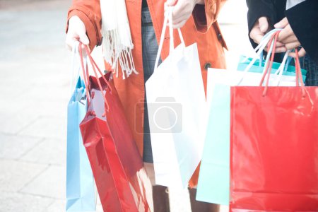 Photo for Shopping women with shopping bags on street - Royalty Free Image