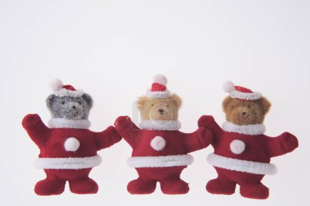 christmas teddy bears with santa claus clothes on white background