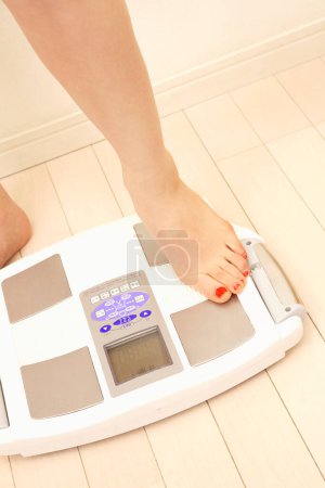 Photo for Close up woman measuring weight - Royalty Free Image