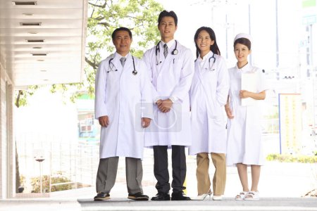 Photo for Japanese medical staff standing near hospital - Royalty Free Image