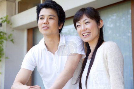 Photo for Asian couple on balcony at home - Royalty Free Image