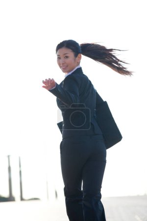 Photo for A woman in a business suit  running on street - Royalty Free Image