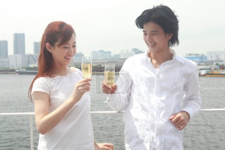 Téléchargez les photos : Un homme et une femme tenant des verres de champagne sur la terrasse - en image libre de droit