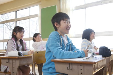 Photo for Japanese children sitting at desks in classroom - Royalty Free Image