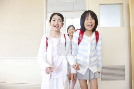 Photo for Portrait of happy asian schoolgirls entering classroom - Royalty Free Image