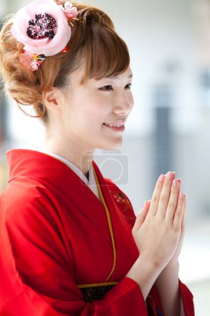 Photo for Portrait of beautiful Japanese woman in kimono praying in shrine - Royalty Free Image
