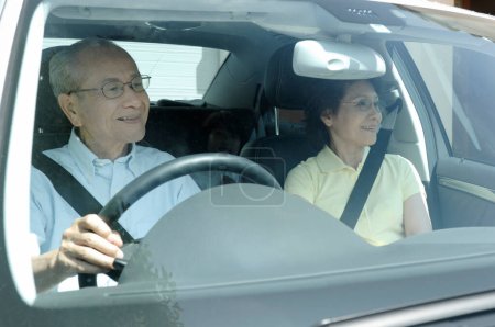 Photo for Senior asian man driving his car with his wife  in the car - Royalty Free Image