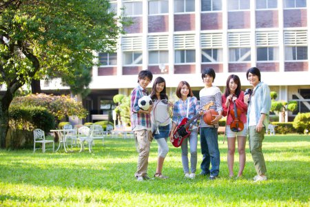 Photo for Happy group of students from music and sport sections near campus building - Royalty Free Image