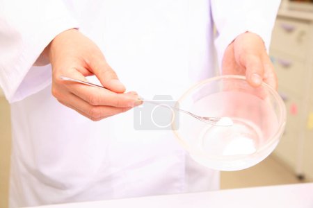Photo for Pharmacist in lab coat mixing medicine in pharmacy store - Royalty Free Image