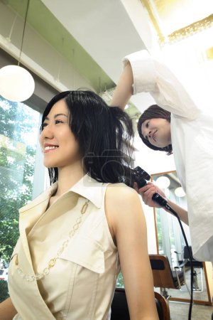 Téléchargez les photos : Portrait de femme japonaise souriante chez le coiffeur - en image libre de droit