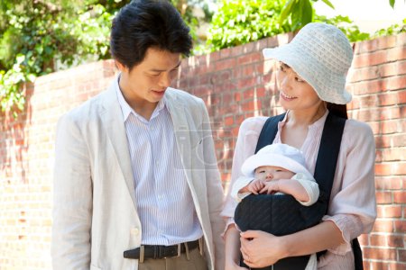 Photo for Asian family with baby walking  in the park - Royalty Free Image