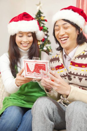 Photo for Close up asian couple reading christmas greeting cards - Royalty Free Image