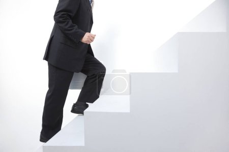 Photo for Low section view of businessman walking up stairs - Royalty Free Image