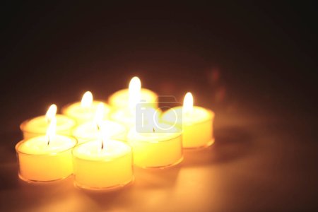 Photo for Many burning candles on black background - Royalty Free Image