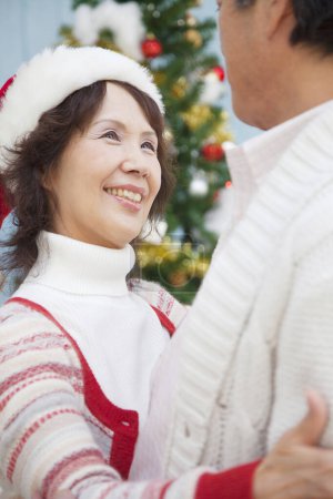 Photo for Asian senior man and woman  celebrating Christmas dancing  at home - Royalty Free Image