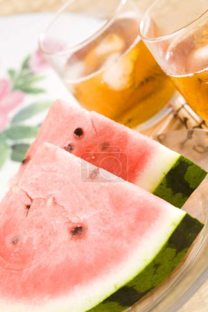 Photo for Close up view of watermelon slices and cold tea on table. summer snacks and drinks - Royalty Free Image