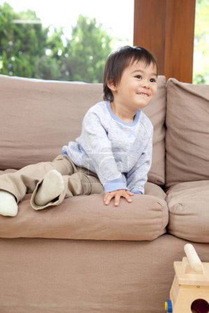 Photo for Little asian boy playing on the sofa - Royalty Free Image