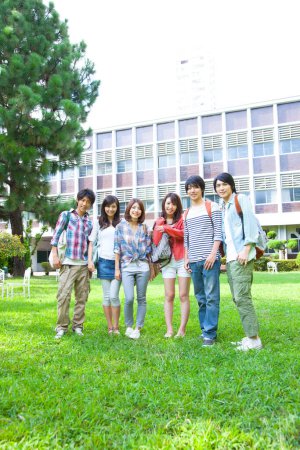 Photo for Asian happy college students groupmates posing near university - Royalty Free Image