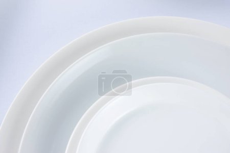 Photo for Empty white plates on grey background - Royalty Free Image