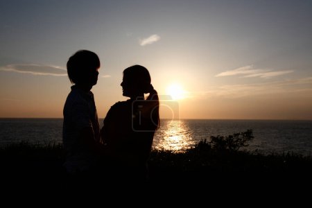 Photo for Couple of young man and woman in love kissing at sunset - Royalty Free Image