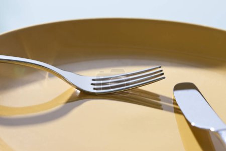 Photo for Empty plate, fork and knife  on table - Royalty Free Image