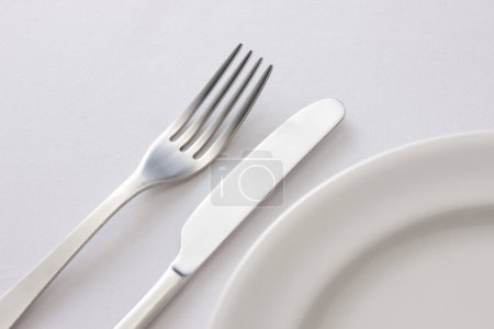 Photo for White plate and cutlery on the table - Royalty Free Image